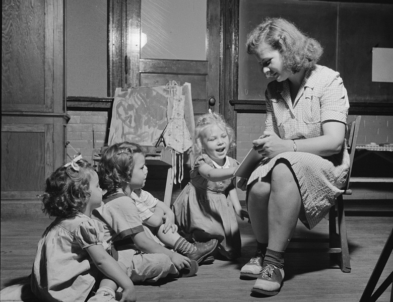 Teacher reading to children at a federally funded childcare center, 1943